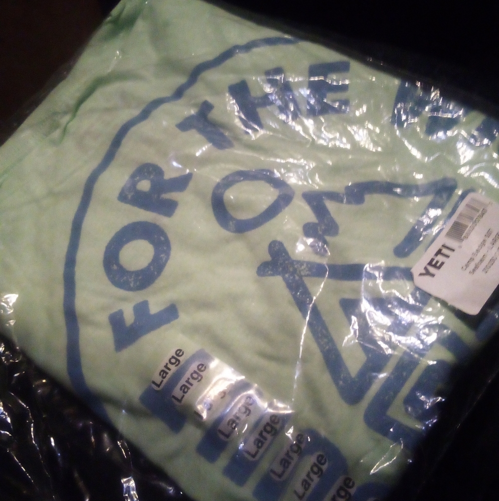 brand new yeti shirts with tags in bag